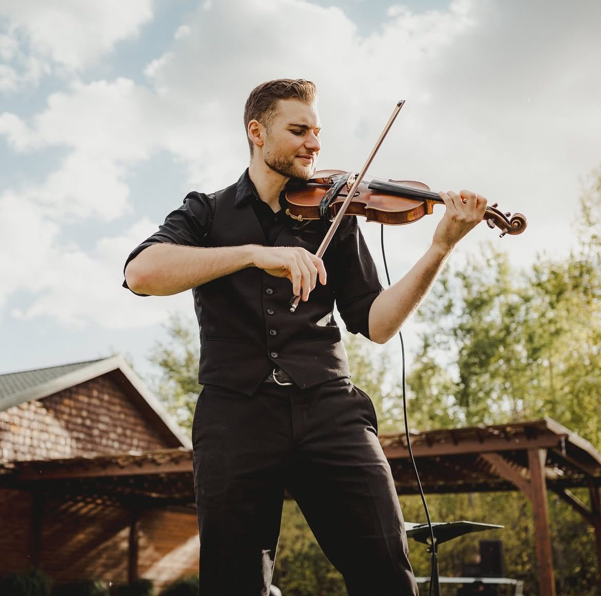 Allan Palmer performing violin outdoors